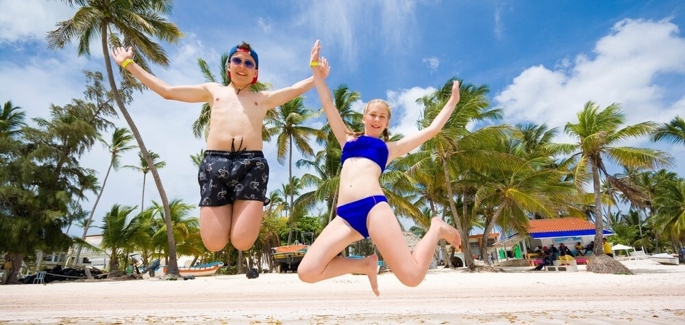 kids jumping in punta cana beach